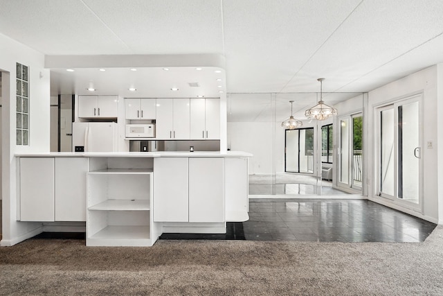300 High Point Dr Unit 313, Hartsdale, NY 10530 - kitchen featuring white appliances, dark colored carpet, white cabinetry, open shelves, and hanging light fixtures