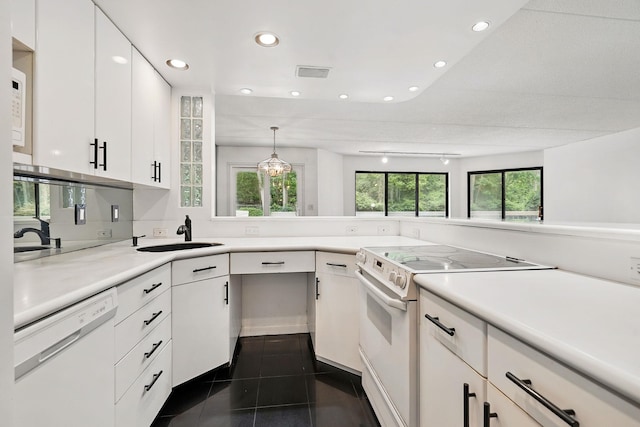 300 High Point Dr Unit 313, Hartsdale, NY 10530 - kitchen with white appliances, a sink, white cabinets, light countertops, and recessed lighting