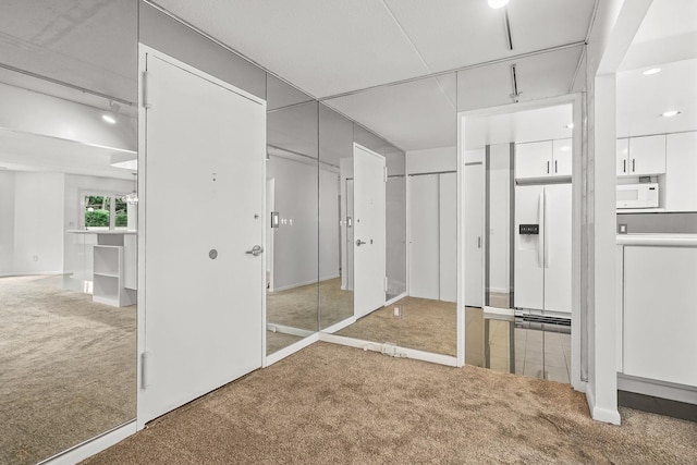 300 High Point Dr Unit 313, Hartsdale, NY 10530 - unfurnished bedroom with carpet floors and white refrigerator with ice dispenser