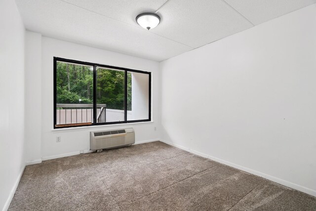 300 High Point Dr Unit 313, Hartsdale, NY 10530 - unfurnished room with a wall mounted air conditioner, carpet flooring, and baseboards