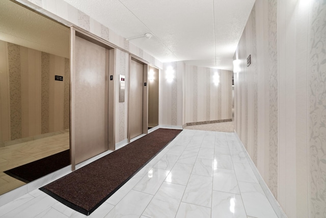 300 High Point Dr Unit 313, Hartsdale, NY 10530 - hall with wallpapered walls, elevator, a textured ceiling, and light marble finish flooring