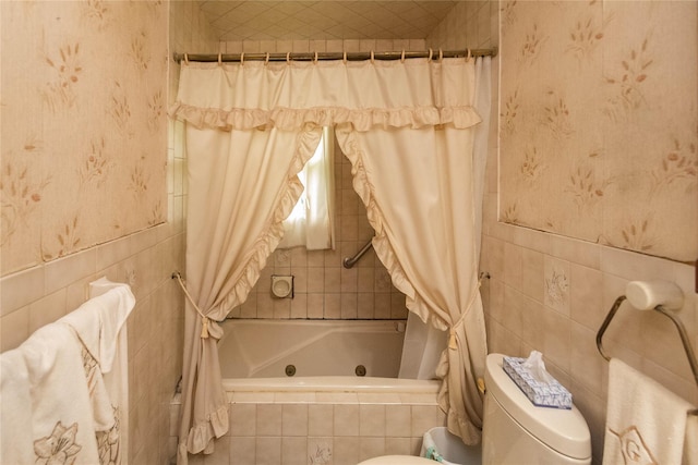 3042 Gomer St, Yorktown Heights, NY 10598 - bathroom featuring tile walls, a combined bath / shower with jetted tub, wallpapered walls, and toilet