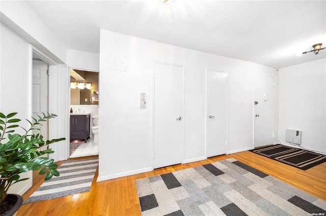 unfurnished bedroom with wood finished floors and connected bathroom