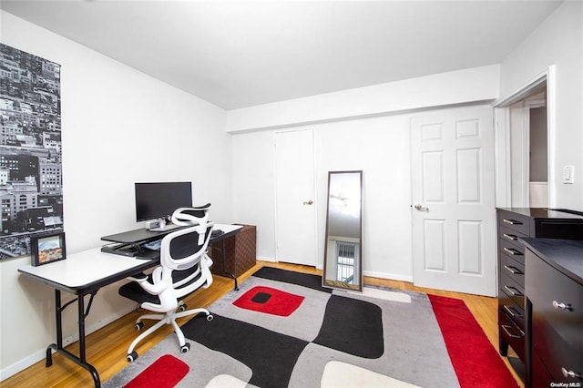 office space featuring wood finished floors and baseboards