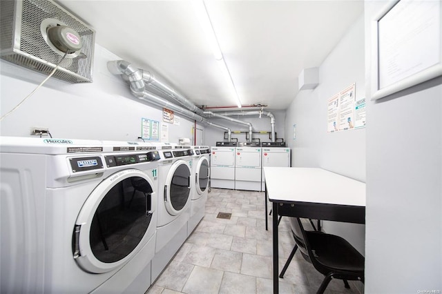 shared laundry room with separate washer and dryer and a garage