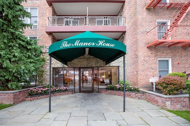 doorway to property featuring a balcony