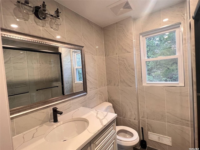 332 Browns Rd, Nesconset, NY 11767 - bathroom with tile walls, tiled shower, toilet, plenty of natural light, and vanity