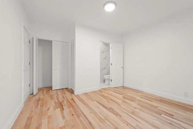 166-03 69th Ave, Fresh Meadows, NY 11366 - unfurnished bedroom with light wood-style flooring, baseboards, a closet, and ensuite bath