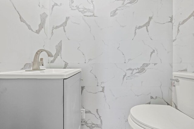 166-03 69th Ave, Fresh Meadows, NY 11366 - bathroom with tile walls, toilet, and vanity