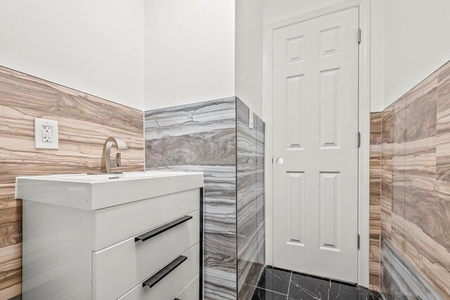 166-03 69th Ave, Fresh Meadows, NY 11366 - bathroom featuring tile walls, wainscoting, and vanity