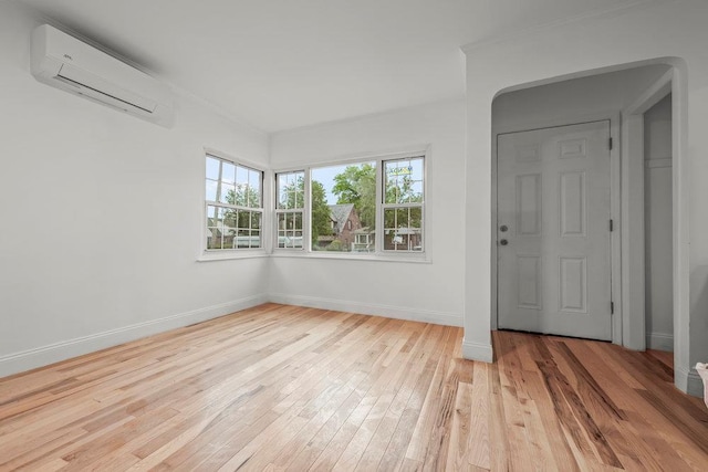 166-03 69th Ave, Fresh Meadows, NY 11366 - empty room with a wall unit AC, light wood-type flooring, baseboards, and ornamental molding
