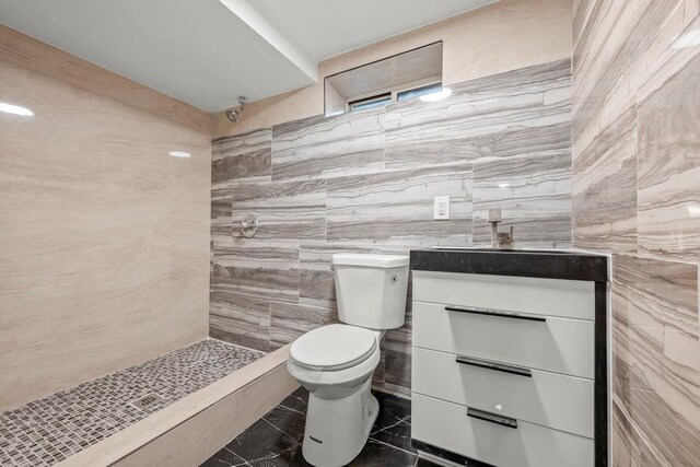 166-03 69th Ave, Fresh Meadows, NY 11366 - full bath with a tile shower, toilet, vanity, and tile walls