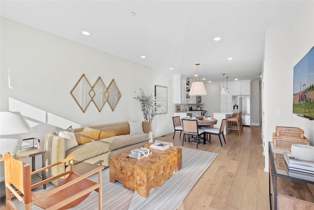 living room with light wood-style flooring and recessed lighting