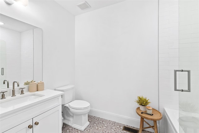 bathroom with toilet, tile patterned flooring, vanity, and baseboards