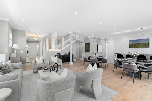 living area featuring stairs, recessed lighting, light wood-type flooring, ornamental molding, and baseboards