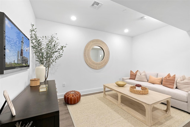 living area with wood finished floors, baseboards, and recessed lighting