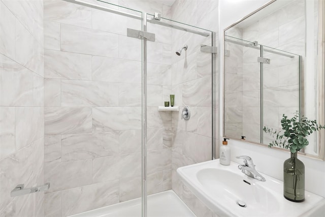 full bathroom featuring a stall shower and a sink