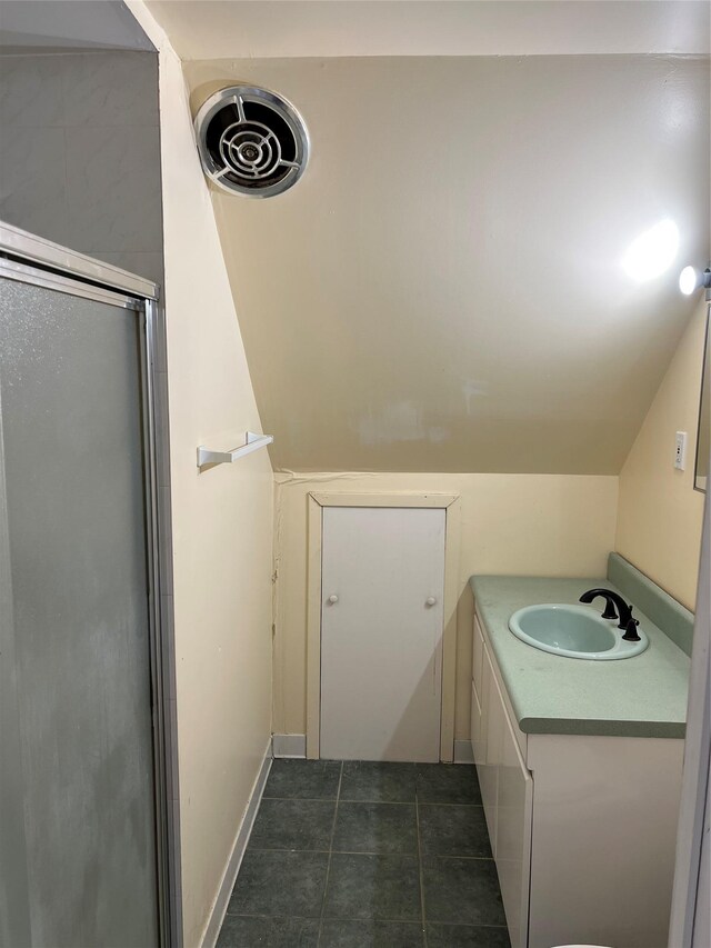 bathroom with vanity, tile patterned floors, and a shower with door