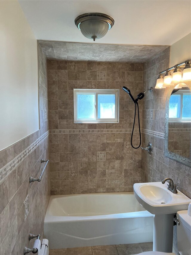 full bath featuring tile walls, bathtub / shower combination, toilet, and tile patterned flooring