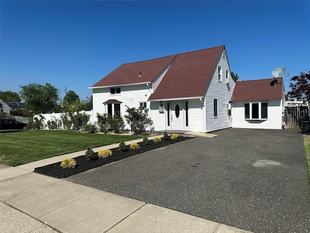 view of front of property with driveway and a shingled roof