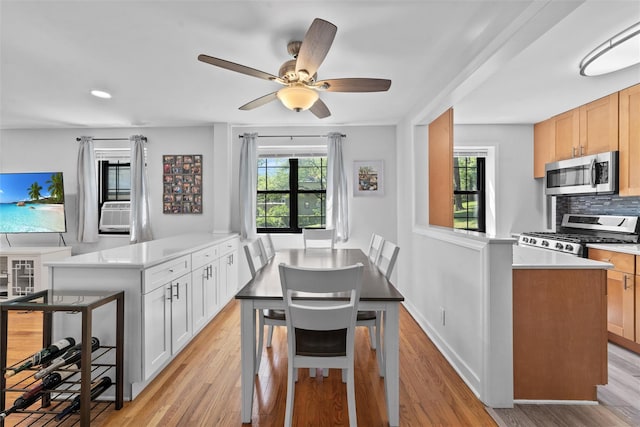 1271 California Rd Unit 1L, Eastchester, NY 10709 - kitchen with stainless steel appliances, a peninsula, light wood-style floors, light countertops, and recessed lighting