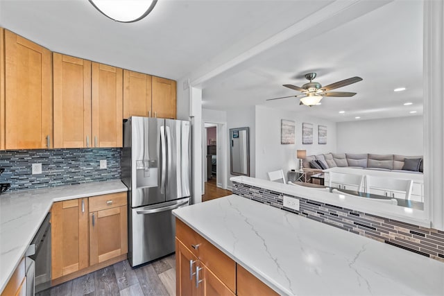 1271 California Rd Unit 1L, Eastchester, NY 10709 - kitchen with stainless steel fridge with ice dispenser, light wood-style floors, decorative backsplash, ceiling fan, and light stone countertops
