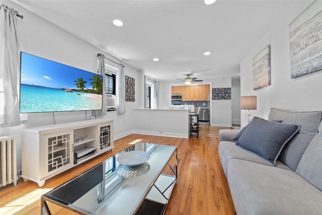 1271 California Rd Unit 1L, Eastchester, NY 10709 - living room featuring radiator heating unit, recessed lighting, light wood finished floors, ceiling fan, and baseboards