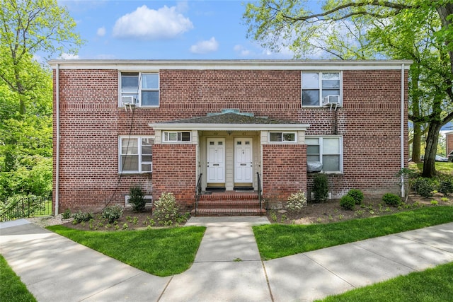 townhome / multi-family property with brick siding
