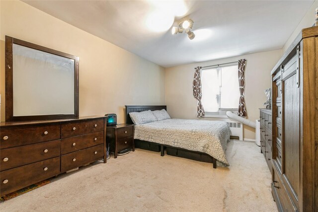 bedroom with carpet flooring and radiator heating unit