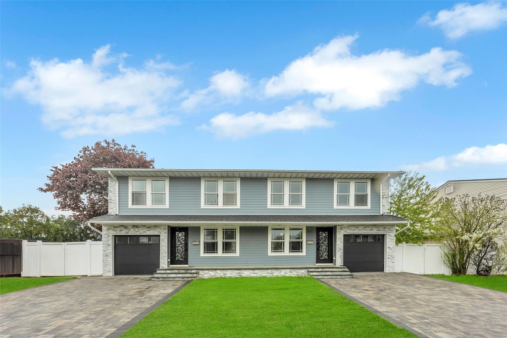 821-823 N Jefferson Ave, Lindenhurst, NY 11757 - view of front facade with decorative driveway, a porch, a garage, and stone siding