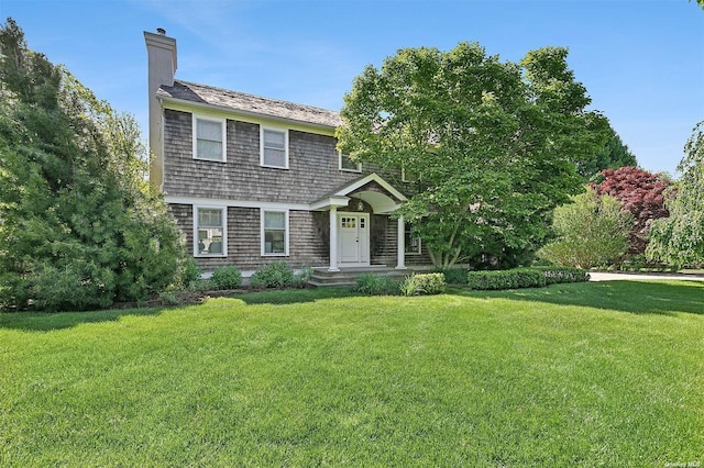 394 Mill Rd, Westhampton, NY 11977 - colonial inspired home featuring a chimney and a front lawn