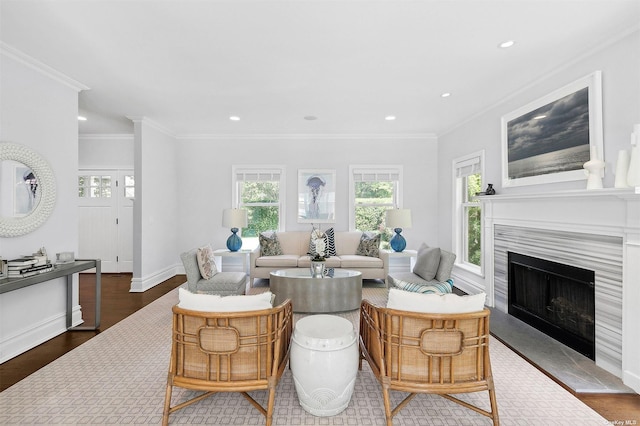 394 Mill Rd, Westhampton, NY 11977 - living area with ornamental molding, a fireplace with raised hearth, wood finished floors, baseboards, and recessed lighting