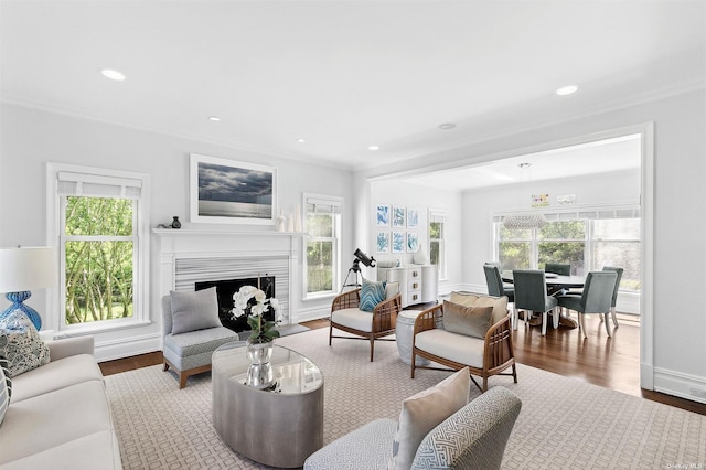 394 Mill Rd, Westhampton, NY 11977 - living room featuring plenty of natural light, wood finished floors, crown molding, a fireplace with flush hearth, and recessed lighting