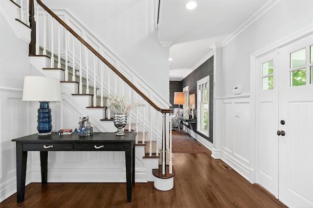 394 Mill Rd, Westhampton, NY 11977 - foyer entrance with ornamental molding, stairs, wood finished floors, a decorative wall, and wainscoting