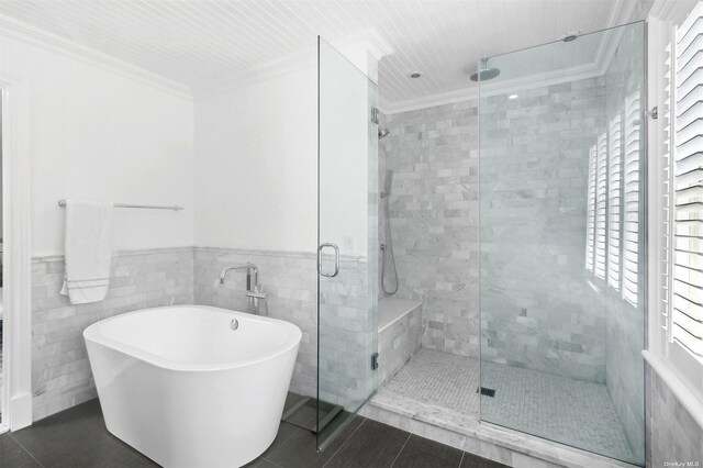 394 Mill Rd, Westhampton, NY 11977 - full bath featuring a shower stall, a soaking tub, tile patterned floors, ornamental molding, and tile walls