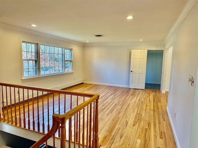 spare room with light wood-type flooring, crown molding, recessed lighting, baseboards, and a baseboard radiator