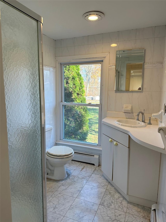 bathroom featuring a baseboard heating unit, marble finish floors, toilet, vanity, and an enclosed shower