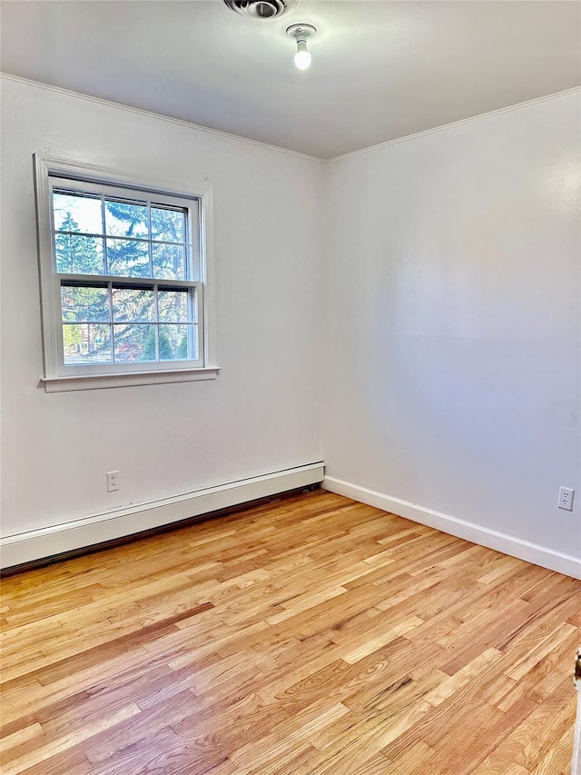unfurnished room with a baseboard radiator, light wood-type flooring, ornamental molding, and baseboards