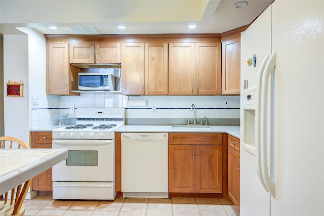 kitchen with white appliances, a sink, backsplash, recessed lighting, and light tile patterned floors
