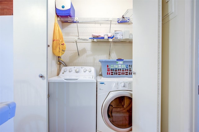 clothes washing area featuring washer and dryer