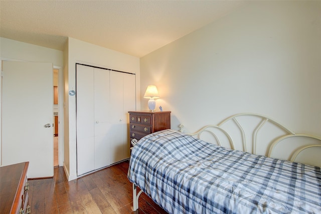 bedroom with hardwood / wood-style floors and a closet