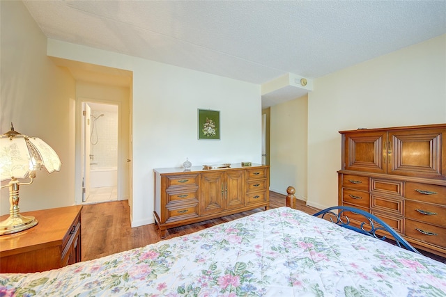 bedroom with wood finished floors and baseboards