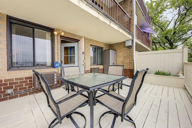view of patio / terrace with outdoor dining area, a balcony, and a deck