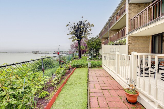 view of yard featuring a water view and fence