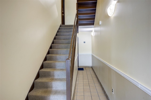 stairs with tile patterned floors