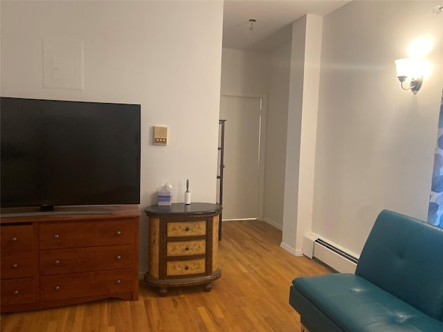 8410 101st St Unit 3U, Richmond Hill, NY 11418 - sitting room with a baseboard radiator, light wood-style flooring, and baseboards