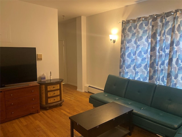 8410 101st St Unit 3U, Richmond Hill, NY 11418 - living room featuring a baseboard radiator and light wood finished floors