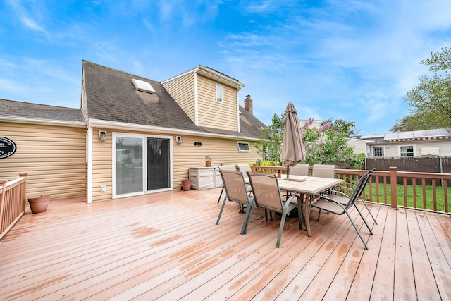 wooden terrace with outdoor dining space