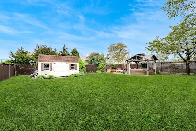 view of yard featuring a gazebo, a shed, an outdoor structure, and an outdoor living space