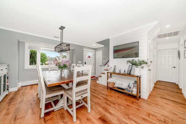 dining room with light wood finished floors, ornamental molding, baseboards, recessed lighting, and stairway